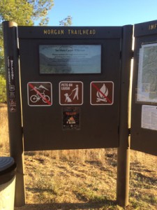 sign for hikers at morgan trailhead with map and no bikes or fires warning