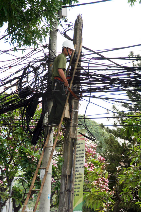 Electrician with a mess of wires in Ho Chi Minh City, Vietnam