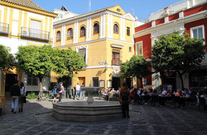 Square with a fountain and outdoor cafe in Seville, Spain.